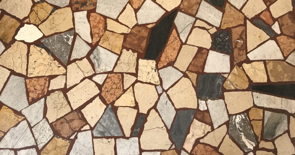 A reflection of in the media: A quarry stone mosaic in various shades of red, brown and gray.